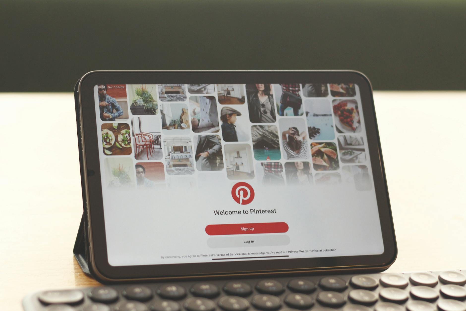 Tablet z otwartym Pinterestem na biurku obok klawiatury